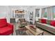 An open-concept living room with cozy furniture, and an open view to the kitchen at 5337 S Ukraine Way, Aurora, CO 80015