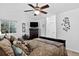 A carpeted main bedroom featuring a ceiling fan, dresser with TV, and pillows on the bed at 5337 S Ukraine Way, Aurora, CO 80015