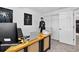 Well-lit office space featuring neutral walls, plush carpeting and a functional work area at 5337 S Ukraine Way, Aurora, CO 80015