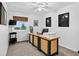A home office setup featuring a computer, printer, desk, ceiling fan, and a window providing natural light at 5337 S Ukraine Way, Aurora, CO 80015