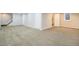 Spacious carpeted basement with multiple doors, offering versatility for various uses at 3257 S Geneva St, Denver, CO 80231