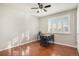 Cozy bedroom featuring hardwood floors, a ceiling fan, and a window with white shutters, complemented by a study desk at 3257 S Geneva St, Denver, CO 80231