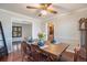 Inviting dining room with wood table, hardwood floors, and decorative ceiling fan at 3257 S Geneva St, Denver, CO 80231