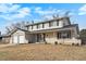 Classic two-story home featuring a brick facade, attached garage, and manicured lawn at 3257 S Geneva St, Denver, CO 80231