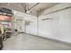 Attached garage with pegboard wall, storage shelves, and interior access to the house at 3257 S Geneva St, Denver, CO 80231