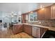Well-equipped kitchen featuring granite countertops, mosaic backsplash, and stainless-steel appliances at 3257 S Geneva St, Denver, CO 80231