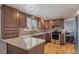 Modern kitchen with granite countertops, stainless steel appliances, and wood cabinets at 3257 S Geneva St, Denver, CO 80231