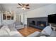 Inviting living room featuring a brick fireplace, hardwood floors, and an open layout at 3257 S Geneva St, Denver, CO 80231