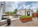 Relaxing backyard patio with outdoor seating, garden beds, and charming garden house at 1721 S Jackson St, Denver, CO 80210