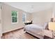 Bright bedroom with hardwood floors, a ceiling fan, and a view of the trees at 1721 S Jackson St, Denver, CO 80210