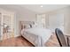 Cozy bedroom featuring hardwood floors and neutral color scheme with easy access to the bath at 1721 S Jackson St, Denver, CO 80210
