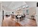 Open-concept dining room with vaulted ceilings, modern lighting, and seamless flow to kitchen at 1721 S Jackson St, Denver, CO 80210