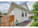 Home exterior showcasing white siding, a fenced yard, and well-manicured landscaping at 1721 S Jackson St, Denver, CO 80210