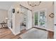Bright foyer featuring wood floors, stylish lighting, and a sliding barn door to office space at 1721 S Jackson St, Denver, CO 80210