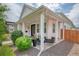 Charming covered front porch with swing and seating area provides a cozy outdoor space at 1721 S Jackson St, Denver, CO 80210
