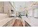 Bright kitchen with marble countertops, stainless steel appliances, and a view to the dining area at 1721 S Jackson St, Denver, CO 80210