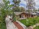 An aerial shot of a home with fresh landscaping, mature trees, and a cozy covered front porch at 2155 S Emerson St, Denver, CO 80210