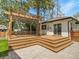 Wooden deck leads to a paver patio with a fenced yard and wooden pergola at 2155 S Emerson St, Denver, CO 80210