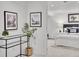 Basement hallway featuring carpet, wall art, and an open doorway to a bedroom at 2155 S Emerson St, Denver, CO 80210