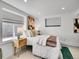 Bright bedroom featuring a full-size bed, two windows, carpet, and white walls at 2155 S Emerson St, Denver, CO 80210
