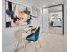Bright bedroom featuring a modern desk, mirror closet, and a comfortable chair at 2155 S Emerson St, Denver, CO 80210