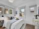 Cozy bedroom featuring a comfortable bed, hardwood floors, and ample natural light at 2155 S Emerson St, Denver, CO 80210