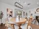 Bright dining room featuring a light wood table, modern lighting fixture, and stylish decor at 2155 S Emerson St, Denver, CO 80210