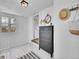 Bright entryway featuring white walls, a storage cabinet with mirror and hat at 2155 S Emerson St, Denver, CO 80210