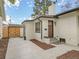 A charming white brick house with a new front door, modern black trim, and fresh landscaping at 2155 S Emerson St, Denver, CO 80210