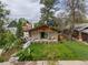 Well-maintained home featuring a spacious front yard and cozy front porch, framed by mature trees at 2155 S Emerson St, Denver, CO 80210