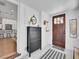 Bright entryway with a wooden door, stylish storage unit and seamless access to kitchen at 2155 S Emerson St, Denver, CO 80210
