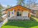 A beautifully renovated home with a covered porch, Colorado flag, and well-manicured lawn at 2155 S Emerson St, Denver, CO 80210