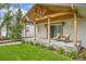 Charming house with a welcoming front porch, a well-manicured lawn, and a freshly painted exterior at 2155 S Emerson St, Denver, CO 80210