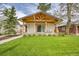 Charming home featuring a covered porch with wooden beams and a well-manicured lawn at 2155 S Emerson St, Denver, CO 80210