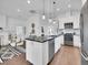 Open-concept kitchen featuring a large island, stainless steel appliances, and hardwood floors at 2155 S Emerson St, Denver, CO 80210
