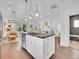 Kitchen area with island seating, stainless appliances, hardwood floors, and access to other living areas at 2155 S Emerson St, Denver, CO 80210