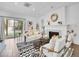 Cozy living room with a fireplace, stylish seating, and a sliding glass door to the outdoors at 2155 S Emerson St, Denver, CO 80210