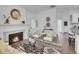 Open concept living space featuring a fireplace, modern decor, and hardwood floors at 2155 S Emerson St, Denver, CO 80210