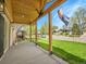 Covered front porch with wood beam construction showcasing the fresh grass and the neighborhood view at 2155 S Emerson St, Denver, CO 80210