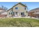 Spacious backyard with a patio, dining set, and well-maintained lawn at 746 Poppywood Dr, Highlands Ranch, CO 80126