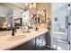 Primary bathroom with dual sinks, dark wood cabinets, chrome hardware, and separate tub and shower area at 746 Poppywood Dr, Highlands Ranch, CO 80126