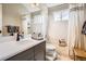 Bright bathroom featuring a shower-tub combo, large mirror, and modern vanity at 746 Poppywood Dr, Highlands Ranch, CO 80126