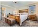 Bedroom with carpet floor, bed, chest, large window, ceiling fan, and neutral wall paint at 746 Poppywood Dr, Highlands Ranch, CO 80126