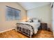 Bedroom features a bed, hardwood floors, a large window, and neutral wall paint at 746 Poppywood Dr, Highlands Ranch, CO 80126