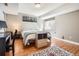 Comfortable bedroom with hardwood floors, a patterned rug, and natural light at 746 Poppywood Dr, Highlands Ranch, CO 80126