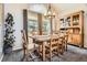 Cozy dining room with a rustic table set, natural light, and built-in cabinetry at 746 Poppywood Dr, Highlands Ranch, CO 80126