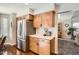 Bright kitchen featuring stainless steel refrigerator, light countertops, and wood cabinets at 746 Poppywood Dr, Highlands Ranch, CO 80126