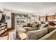 Living room features a large sofa, backyard access with patio and a kitchen counter bar with seating at 746 Poppywood Dr, Highlands Ranch, CO 80126
