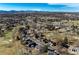 Sweeping aerial perspective of the neighborhood, showcasing its proximity to a golf course and mature trees at 22 Wedge Way, Littleton, CO 80123