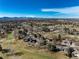 Elevated view showing the neighborhood's location near a golf course, with mature trees and manicured green spaces at 22 Wedge Way, Littleton, CO 80123